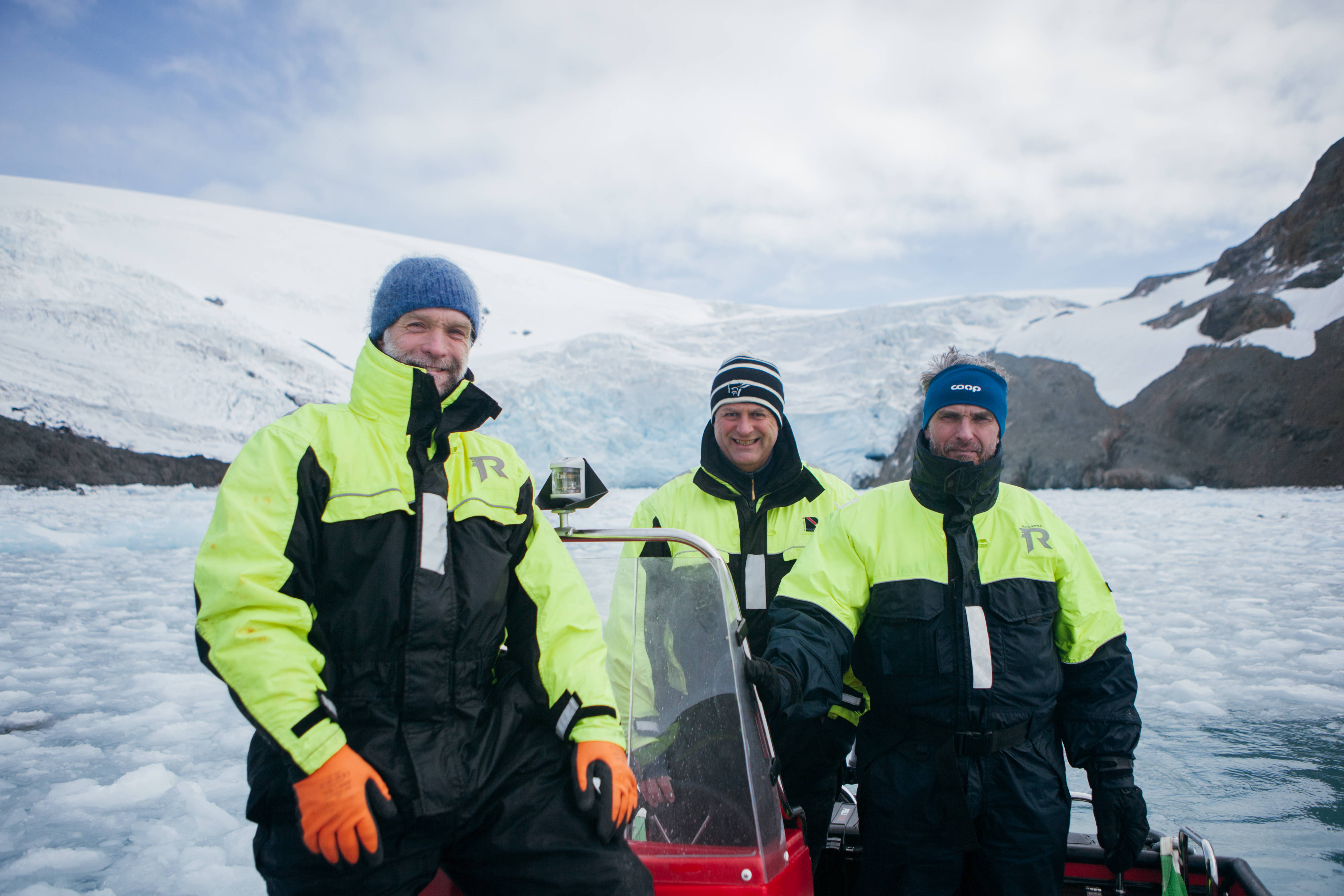 Three male researchers on a boat in The Southern Ocean