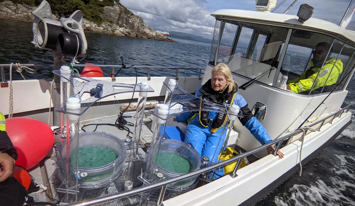 Small boat on the fjord with scientific equipment and researchers on board.