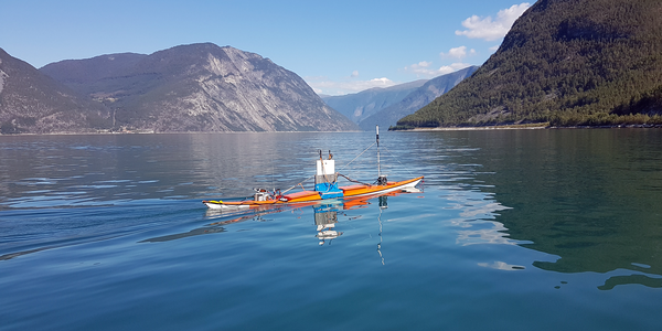 

photo of an uncrewed kayak on the fjord
